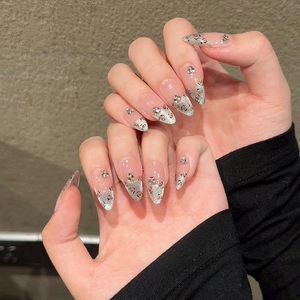 Handmade stiletto press-on nails with silver leopard print, cat eye glitter, and crystals
