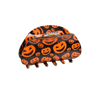 Halloween claw clip featuring orange Jack-o'-lantern patterns on a sleek black finish