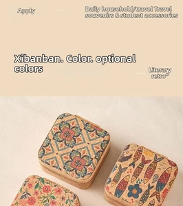 Macro shot of portable square cork jewelry boxes with vintage floral and tile patterns