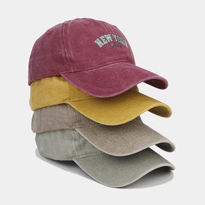 Vintage washed cotton baseball caps stacked in multiple colors with New York embroidery