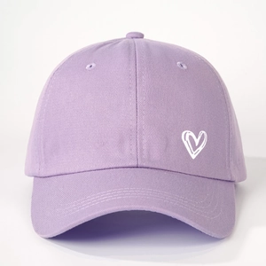 Close-up of heart embroidery on light purple cotton twill baseball cap fabric