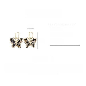 Detailed view of leopard print acetate butterfly earrings with 4cm by 5cm size specs