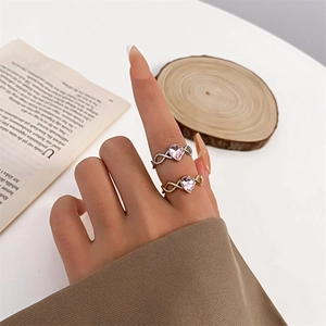 Infinity band ring set with heart-shaped pink zircon stones in silver and gold finish