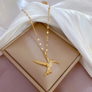 Elegant gold hummingbird necklace with white crystals on silk and jewelry box