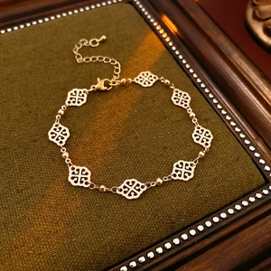 Detailed close-up of a hollowed rhombus cloud bracelet on dark green velvet background