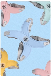 Macro display of reflective mesh dog harnesses in pink, green, blue, and yellow