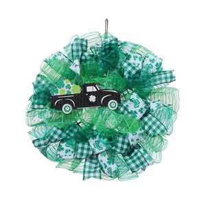 St. Patrick's Day wreath with green clover ribbons and a black truck on a white background