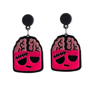 Exaggerated pink acrylic brain earrings with black cartoon monster accents on white background