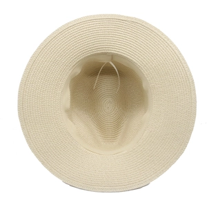 Interior detail of a straw Panama hat featuring a beige woven texture and adjustable white cord