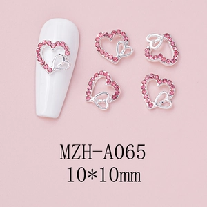 Close-up of pink heart rhinestones with silver hollow bow for DIY nail art 10x10mm
