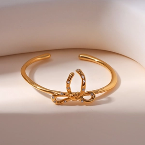Bracelet jonc ouvert nœud doré en acier 316L avec cristaux de zircone pour femmes