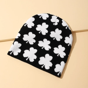 Winter knitted beanie featuring black and white clover pattern for warm outdoor wear