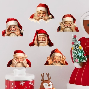 Detail of six Santa Claus emoji wall stickers arranged with festive Christmas decorations