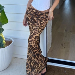 Detail of high waist leopard print maxi skirt featuring mesh fabric and bodycon fit