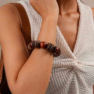 Detailed macro shot of vintage wooden and coconut shell beads on a bohemian wrist bracelet