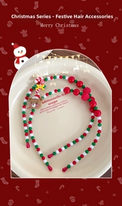 Close-up of beaded Christmas headbands featuring a festive bear and candy cane details