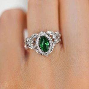 Elegant marquise cut emerald green zircon ring with silver leaf textured band and pavé crystals