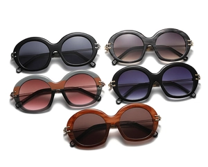Detailed view of various round frame vintage sunglasses with golden metal chain hinges