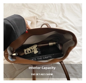 Interior view of brown tote bag showing spacious capacity, lining, and zipper pocket