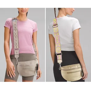 Detail of crossbody bag featuring textured lychee leather and ethnic jacquard wide strap