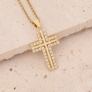 Macro detail of 18K gold layered cross pendant with micro-pave zircons and O-chain