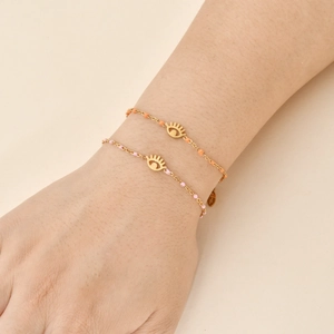 Set of two gold stainless steel evil eye bracelets with pink and orange beads