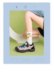 Close-up of white crew socks with yellow smiley face patches and stylish letter prints