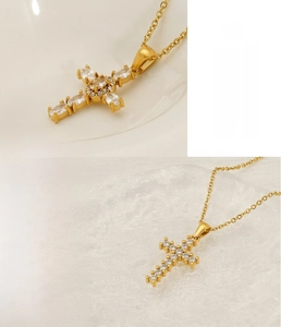 Detail of gold stainless steel cross necklace with sparkling marquise zircon inlay
