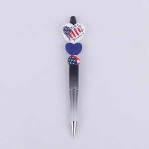 Close-up of beaded ballpoint pen with Patriotic Faith Family Freedom silicone heart charms