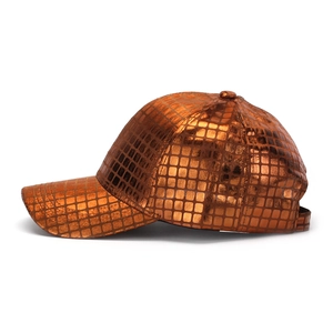 Detail of baseball cap showing metallic copper grid texture and curved visor design