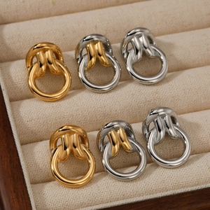 Classic stainless steel twisted hoop earrings in gold and silver finish set on velvet