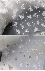 Detailed 5D nail art sticker featuring embossed white butterflies and pearls
