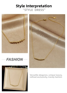 Detail of 18K gold-plated necklace with micro-paved zircon curved bar pendant