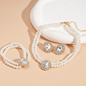 Detailed view of luxury vintage pearl jewelry set with crystals and gold finish