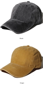 Detail of washed cotton baseball caps in black and ginger colors with vintage texture
