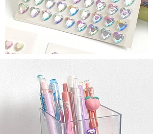 Close-up of heart-shaped iridescent 3D diamond stickers with stationery storage scene