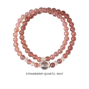 Close-up of strawberry crystal beaded bracelets with silver bow charms and clear crystals