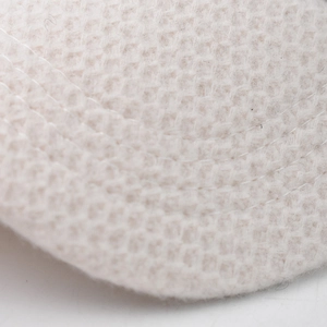 Detailed macro view of the beige waffle knit fabric and premium double stitching on the cap