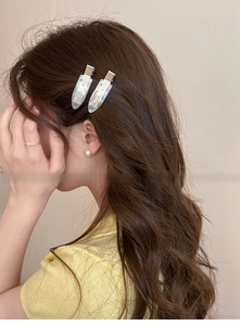 Detail of elegant water drop hair clip with colorful rhinestones on a female model