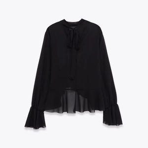 Detail of black long-sleeve chiffon blouse with bow tie neck and ruffled elastic cuffs