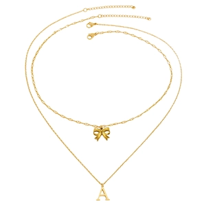 Double-layered golden necklace with a bow pendant and letter A charm on a white background