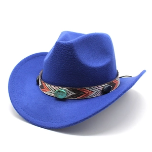 Close-up of ethnic woven band with turquoise stone on blue felt cowboy hat