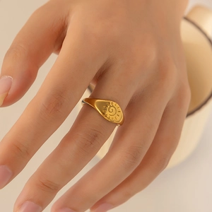 Detailed view of an irregular 18k gold-plated stainless steel ring with sun engraving