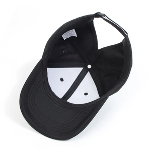 Inside view of black baseball cap showing durable twill fabric and white care label