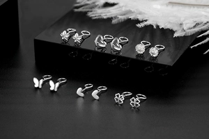 Detail of six S925 sterling silver stud earrings in butterfly and clover shapes