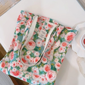 Detail of oil painting floral canvas tote bag with rose print and white webbing handles