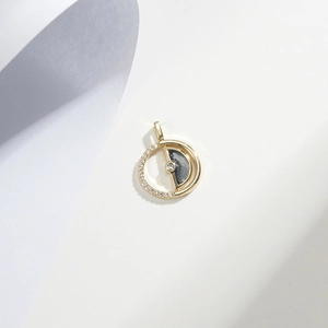Gold-plated round pendant with inlaid crystal rhinestones and dark grey enamel finish