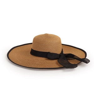 Detailed close-up of woven straw texture and black mesh bow on wide brim sun hat