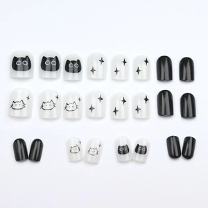Short press-on nails featuring black and white cartoon cats and star patterns, 24 piece set
