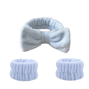 Three-piece light blue plush spa set featuring a bow headband and matching wristbands